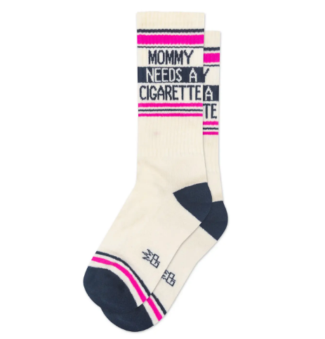 Cream-colored crew socks featuring navy and pink stripes with the phrase MOMMY NEEDS A CIGARETTE knit into the top in bold navy letters.