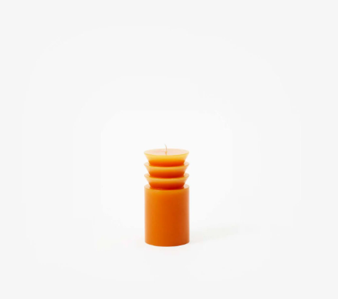 The Areaware Small Totem Candle in terracotta, an unscented paraffin wax sculpture with a layered, abstract form.
