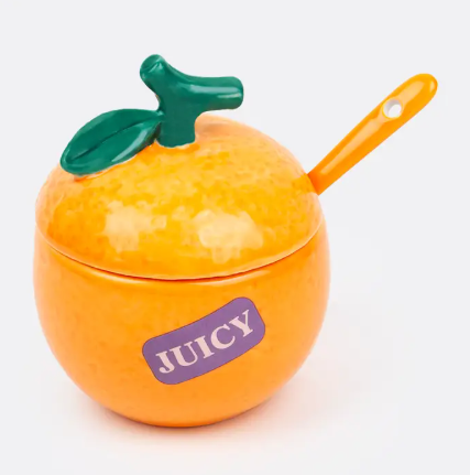 Brighten your coffee station with the Orange Sugar Bowl by DOIY, a realistic ceramic citrus fruit container detailed with a green stem lid and a purple juicy sticker graphic.