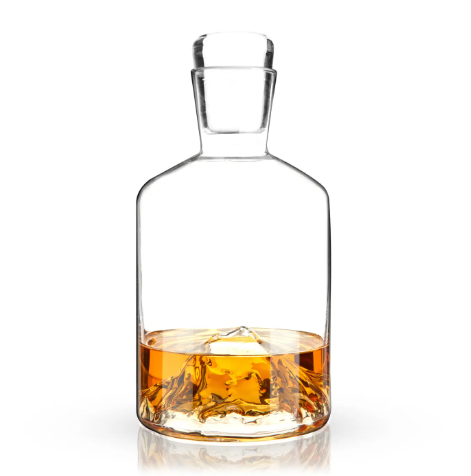 The elegant Viski Pacific Northwest Mountain Decanter filled with amber whiskey.