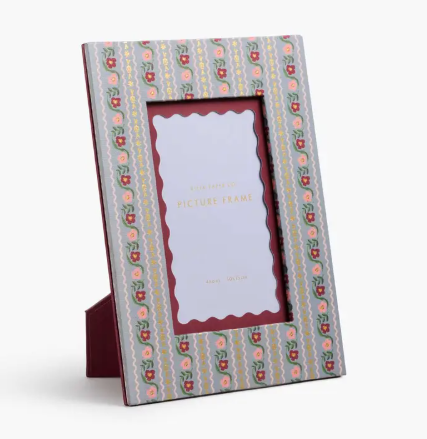 A Rifle Paper Co. Delphine picture frame featuring a red and pink floral stripe pattern and a scalloped interior mat.