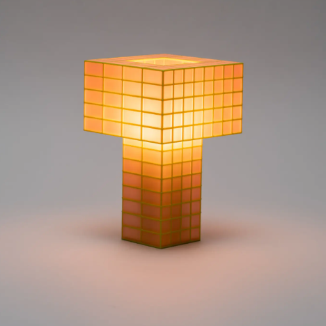 Highlight the warm glow of the Tesser 5:8 Lamp by Ridezign in guava, showcasing its tall sculptural silhouette and Fibonacci-inspired grid pattern.