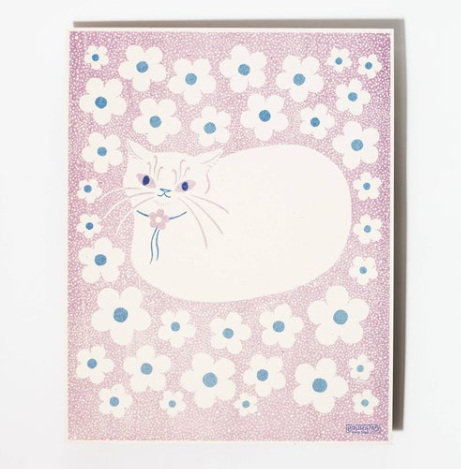 On a scale of one to perfect loaf, this cat is off-the-charts cute, wearing a little flower bolo tie to match the floral background.