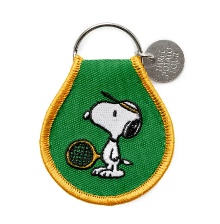 Double-sided Snoopy Tennis patch keychain made from natural oxford cotton with a sturdy metal keyring.