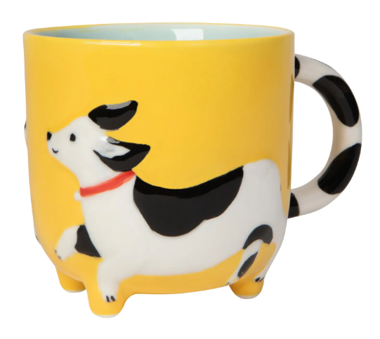 Display the cheerful yellow Spot the Dog Critter Mug by Danica Jubilee, featuring a sculpted puppy wrapping around the base and a spotted handle.