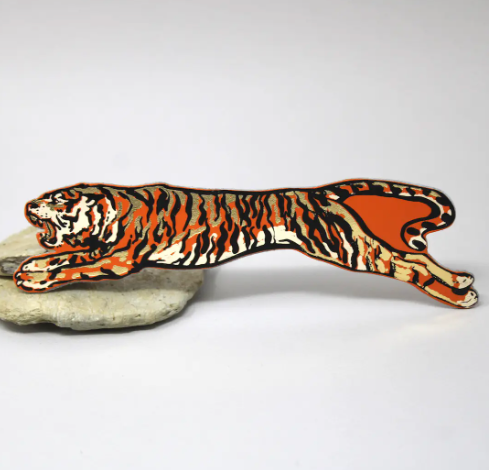 A vibrant orange genuine leather bookmark featuring a hand-foiled tiger design.