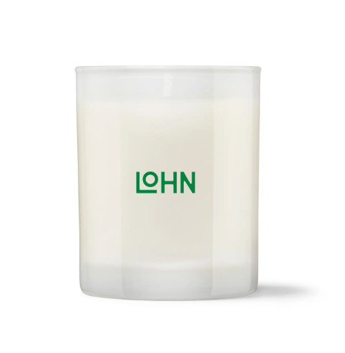 The LOHN Jaro Mandarin & Petitgrain Candle, displayed in its elegant glass vessel with a matching lid and its beautifully designed box featuring a vibrant yellow and green motif.
