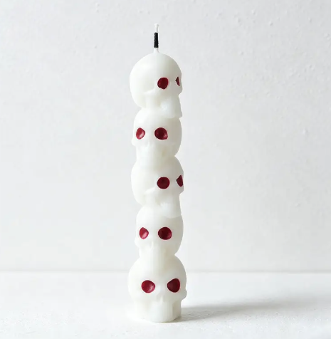 Bring eerie elegance to your decor with the Stacked Skull Halloween Sculpted Candle by CouldNook, crafted in clean white wax with striking red accent details.