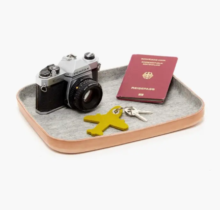 A large Granite Kawabon tray featuring a sculpted Vachetta leather base and a soft Merino wool interior lining.