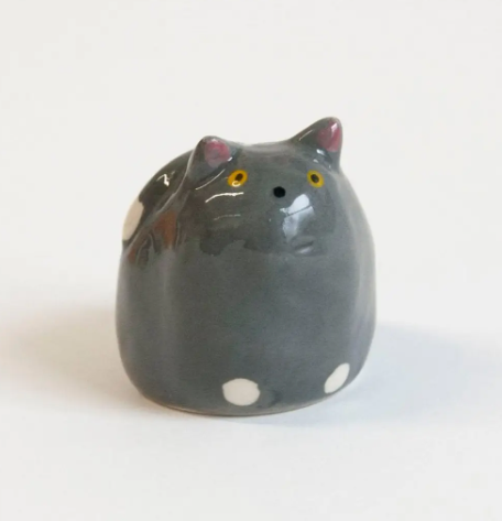 Close-up of the grey cat decorative object from Co.House Designs highlighting its glossy finish and painted details.