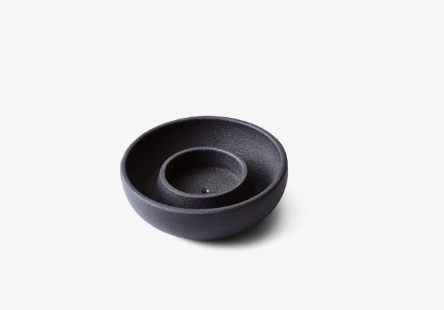 Functional cast iron holder displaying its removable top feature for votives or incense sticks.
