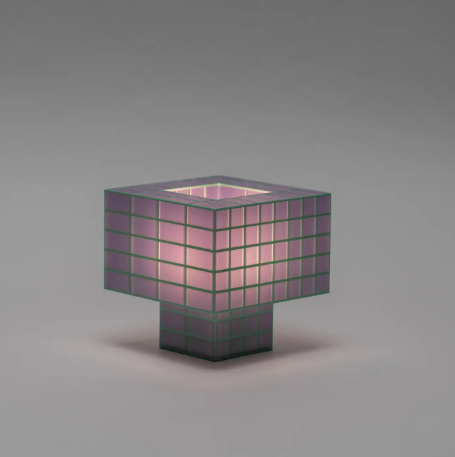 View the rich lavender hue of the Tesser 5-3 Lamp by Ridezign, casting a cozy and inviting light from a tabletop surface.