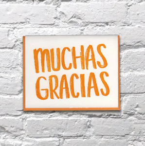 Close-up of the tactile letterpress texture on a Bench Pressed Spanish thank you card with a matching kraft envelope.