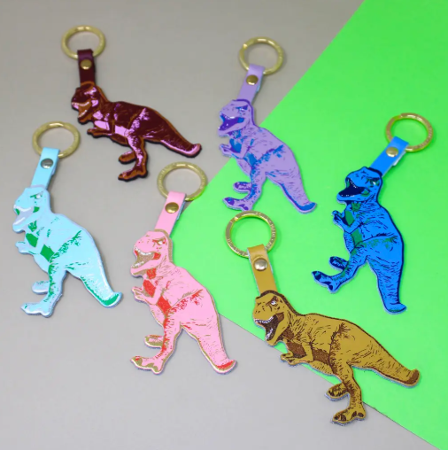 A leather keychain with a T-Rex silhouette in various colors.