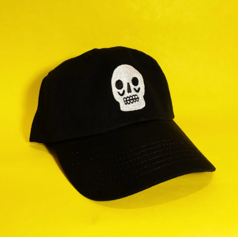 White Kristina Micotti Skull Dad hat with spooky black embroidery, handcrafted in San Jose for a little spooky flair.