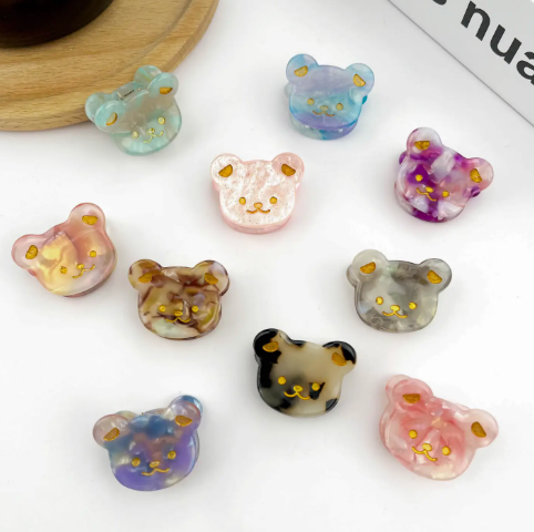 A collection of colorful bear-shaped hair clips with a cute, whimsical design.