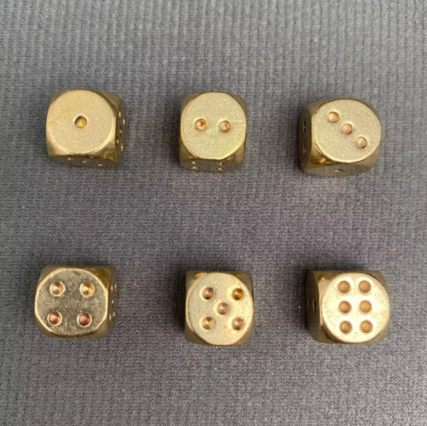 Showcase the complete layout of a high-quality six-sided brass gaming set neatly arranged.