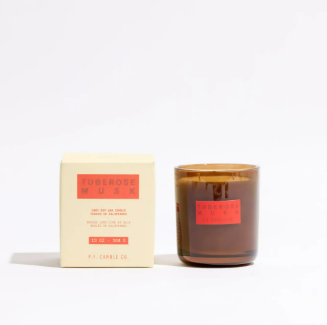 Premium 13 oz double-wick soy candle in a designer gift box featuring a green floral and white musk scent.