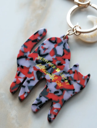 A detailed view of the colorful, custom-blended acetate pattern on the reverse side of the Black Cat Lucky Bag Charm.