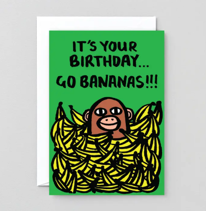 A vibrant green birthday card with a cartoon monkey popping out of a pile of bananas and the text go bananas.