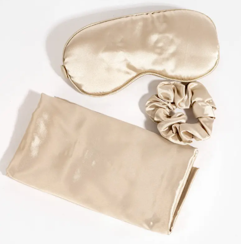 A beautiful satin sleep set including a pillowcase, an eye mask, and a scrunchie, for a luxurious night's rest.