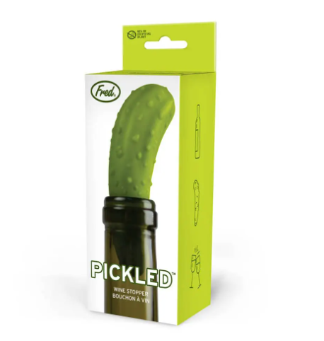 The vibrant retail packaging for the Pickle Bottle Stopper by Fred & Friends, showcasing the playful pickle design on a green gift-ready box.