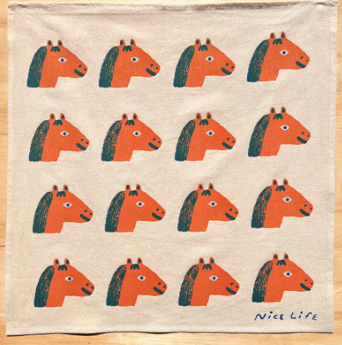 A lovely and fun hand-printed cotton tea towel with a charming horse design, ideal for a modern kitchen.