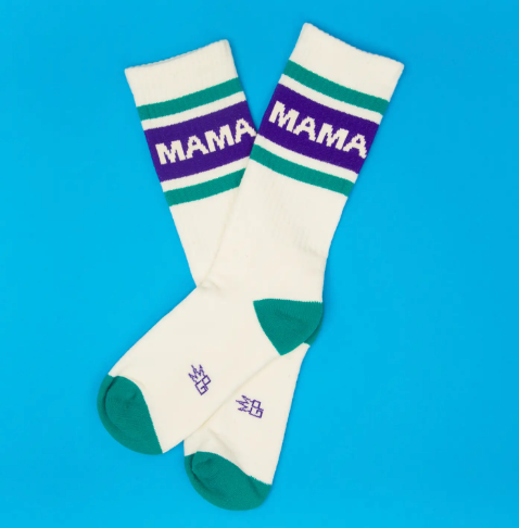 Close up of retro-style athletic socks featuring a teal contrast toe and heel with a bold block-letter "MAMA" statement.