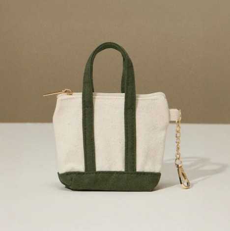 Add a touch of utility and style with the Olive Mini Canvas Pouch Bag Charm by Sensibling Corp., featuring an attached gold chain clip.