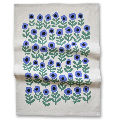 Display the full pattern of the Purple Poppy Tea Towel by Badger & Burke, featuring blue poppy illustrations on an off-white background.