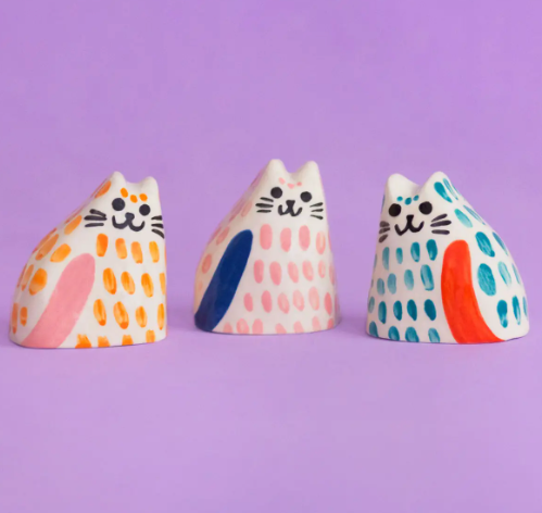 Three Ana Seixas Baby Cats in orange, pink, and teal, arranged together, highlighting their individual colors and charming collective appeal.