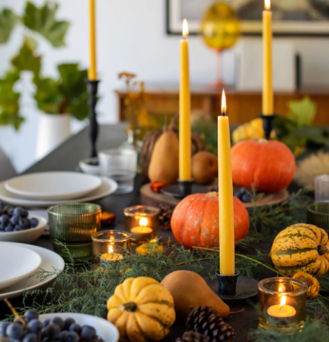 Illuminate your dining table with hand-dipped Beeswax Taper Candles by Bluecorn Candles, styled for a cozy seasonal gathering.
