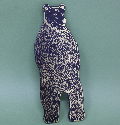 Black bear magnet by Ark Colour Design, showcasing its detailed hand-embossed texture against a solid background.