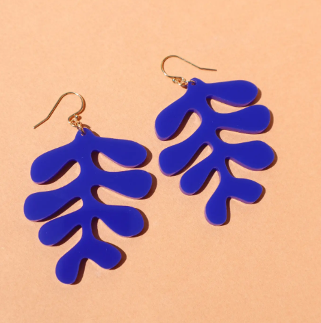 A close-up of the beautiful shiny lapis blue Sango Earrings, highlighting the unique wiggly coral design.