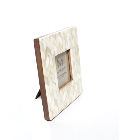 Display the artisan craft of Matr Boomie Fair Trade Artemis 3x3 bone picture frame standing on an easel back.
