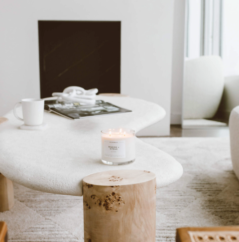 Create an inviting atmosphere with the lit Seaside + Citrus 3-wick candle by Calyan Wax Co. displayed on a modern coffee table.