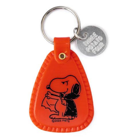 Showcase the vibrant red Snoopy Dracula Saddle Keychain by Three Potato Four, complete with a classic vampire costume graphic and a branded metal charm.