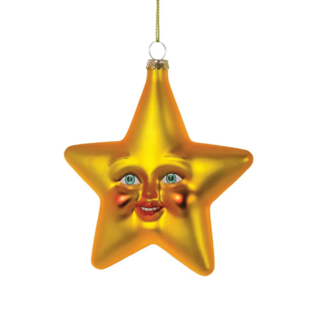 A golden glass Wonderment Star ornament with a whimsical human face, hanging from a gold cord.