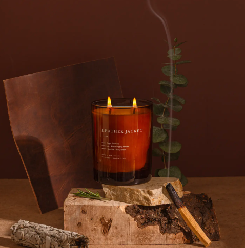 Create a sophisticated atmosphere with the Leather Jacket Candle by Brooklyn Candle Studio, styled with warm leather and botanical elements.