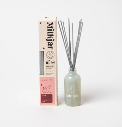 Milkjar Dandy diffuser and its packaging, highlighting the minimalist design and the thumbs-up graphic on the box.