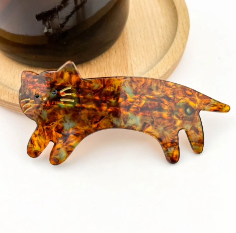 A glossy tortoise cat-shaped hair accessory by TheDivaSoap, showcasing a smooth and polished finish.