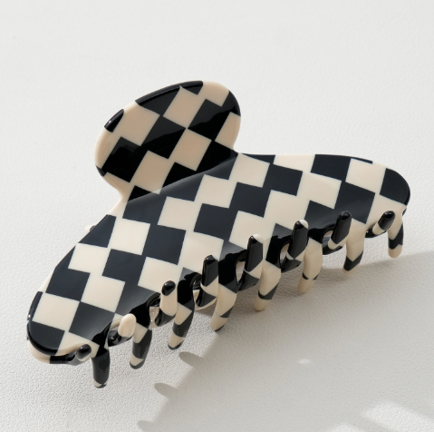 Close-up of the Adrienne style eco-friendly cellulose acetate material on an Adorro checkered hair clip, showing the unique pattern variations.