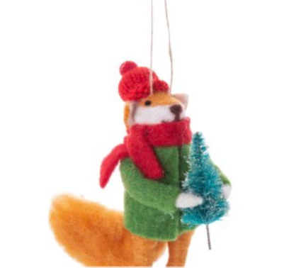 The festive Silver Tree Felt Fox Ornament bundled up in a red scarf and hat, carrying a miniature Christmas tree.