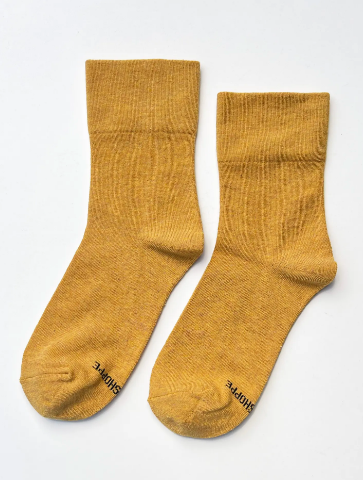 Add a vibrant pop of color to your wardrobe with the breathable Marigold Sneaker Socks by Le Bon Shoppe, crafted for all-day comfort.