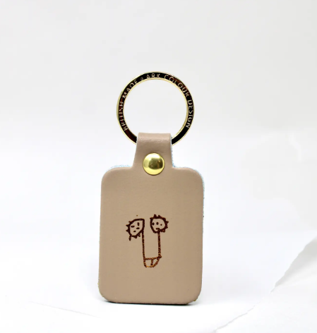 Nude leather willy keyring with a gold-plated ring, a humorous and high-quality novelty keychain.