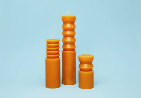 A trio of Areaware Totem Candles in terracotta (Small, Medium, Large) displayed together, showcasing their varying sculptural heights and cohesive aesthetic.