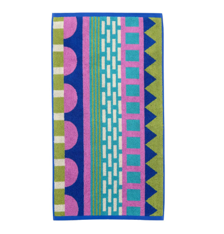 A soft cotton hand towel showcasing a playful, multi-colored geometric block design in bright blues, pinks, and greens.
