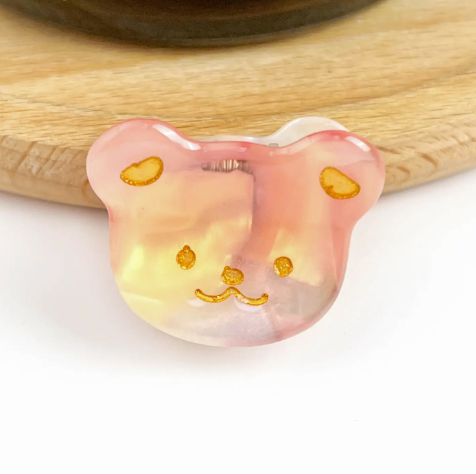 A pink 1 bear head-shaped mini hair clip, showcasing its adorable and fun design.