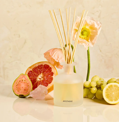 Luxury citrus home fragrance diffuser from APOTHEKE with a minimalist matte-finished glass base and ten-inch scent sticks.