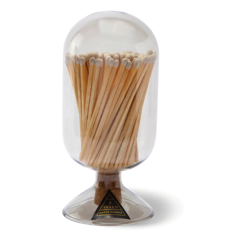 Elevate your fireplace mantle with the Match Cloche by SKEEM in translucent Smoke glass filled with white-tipped matches.